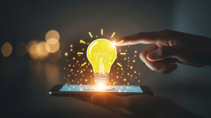Hand touching a smartphone screen with a glowing light bulb symbolizing innovative ideas