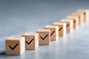 Wooden blocks arranged in a row with checkmark icons, representing approval, completion, verification, and successful outcomes in business processes.