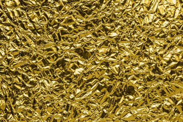 Luxury shiny metallic golden foil crumpled texture background