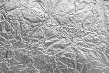 Shiny metal silver gray foil leaf crumpled texture background