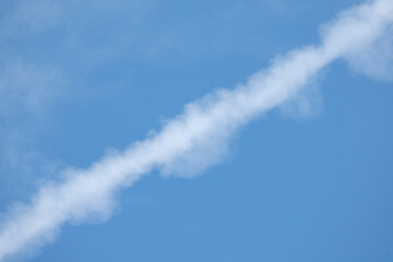 beautiful brilliant and dynamic clouds against blue sky, contrails or condensation trails or vapour trails, line-shaped clouds produced by aircraft engine exhaust or changes in air pressure