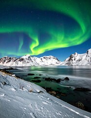 Scenic night view of green aurora borealis dancing over snowy mountains and water