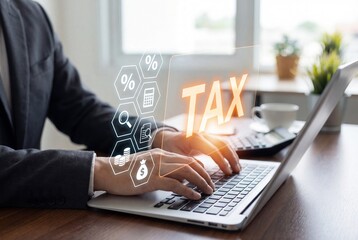 Businessman using laptop with digital tax hologram and financial icons in modern office