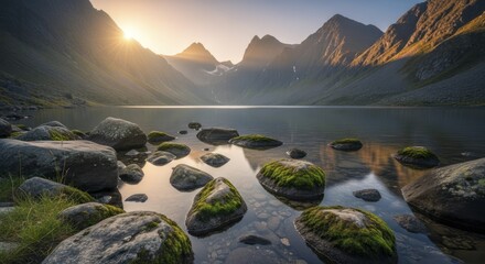 Majestic mountain peaks frame a serene alpine lake at sunrise with moss covered stones in the foreground.