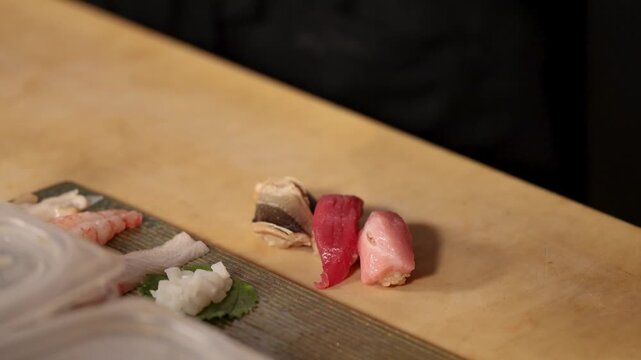 Assorted Nigiri Sushi with Tuna and Shellfish on Wooden Counter