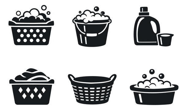 Solid glyph laundry icons set featuring baskets, a bucket, detergent bottle, and washing suds for domestic chores
