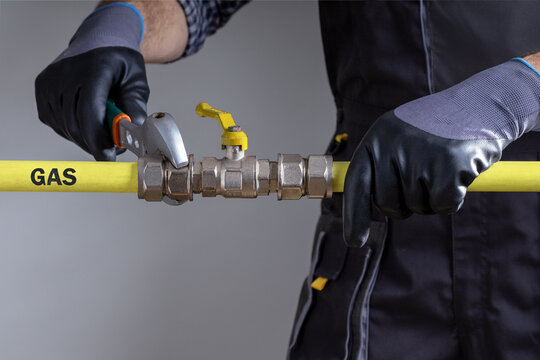 Technician repairing gas pipeline in the house.