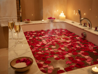 Luxurious Romantic Spa Bath for Two with Abundant Red Rose Petals and Champagne Flutes, Relaxing Ambiance