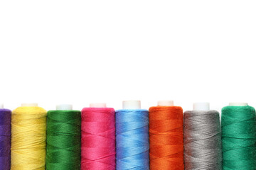 Spools of colorful thread on white background