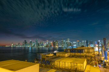 Miami, Florida, The United States - Jan 02 2026: Long Exposure Dark Hours Shot On Brickell District Downtown With Container Vessel Moored In The Harbour