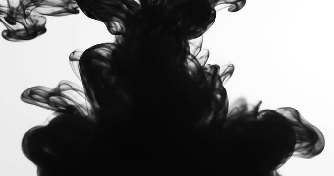 Black ink plume swirling underwater abstract diffusion.