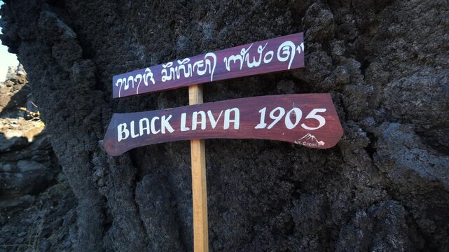 Black lava sign near Mount Batur volcano in Bali