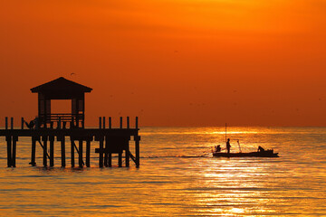 The silhouette of the pavilion with a beautiful sunrise in the morning.