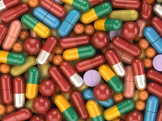  Multicolored pills and capsules are scattered together.