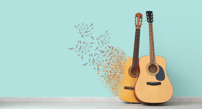 Two guitars near color wall