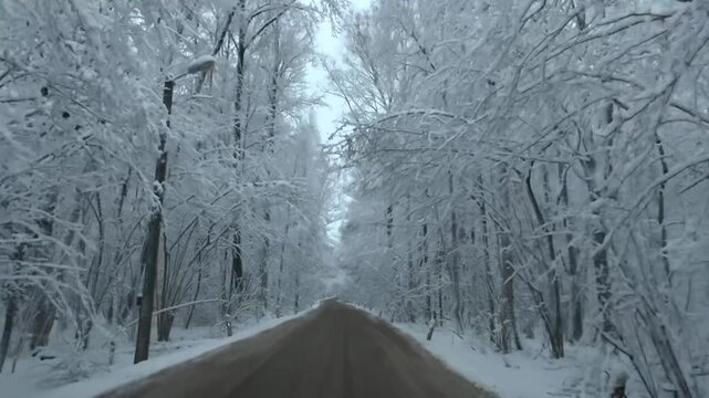 A snow-covered road in Odintsovo, Russia. A stunning landscape of cars on a winter road. The beauty of the scenery is breathtaking