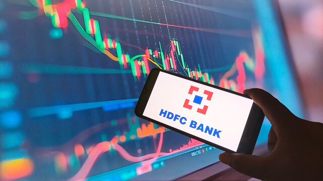 HDFC Bank logo on smartphone screen with stock market graph