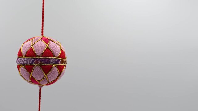 Wide Shot of Sagemon Hanging Hina Ornament on White Background (Left) 4K 60fps