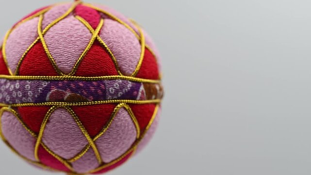 Close‑Up of Sagemon Temari Ornament, Vivid Fabric Texture (Left)