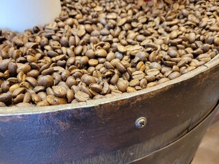 Roasted Coffee Beans Filled in a Vintage Wooden Barrel, Close-up Texture of Fresh Caffeine Seeds