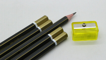 Black wooden pencil with sharpener on white background