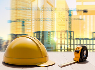Construction planning prepares building development with a safety helmet and measuring tape symbolizing site measurements and upcoming structural work.