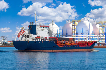 Petrochemical shipping, tanker vessel transfers liquid gas and fuel near industrial storage tanks for energy distribution and chemical logistics LNG, LPG