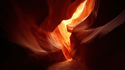 Sunlight illuminates the glowing canyon walls with rich orange and red hues in a breathtaking natural landscape