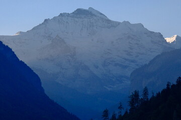 Close-up of Jungfrau summit at early morning, with dawn light illuminating snowcapped peaks