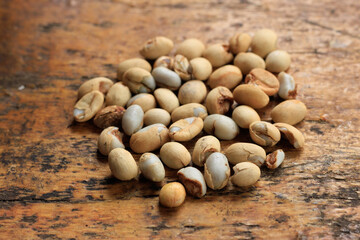 Raw Unroasted Coffee Beans Scattered on Rustic Wooden Surface
