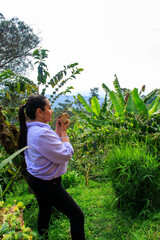 Woman drinking coffee while enjoying mountain view at coffee plantation