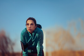 Tired Jogger Regulates her Breath and Feels Exhausted After Running. Runner breathing heavily after a training session outside taking a break