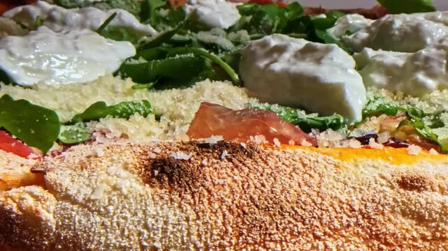 Macro view of pizza with prosciutto and cheese revealing layered textures and warm savory details