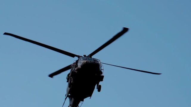 Military Sikorsky UH-60 Black Hawk helicopter in flight up-close slow motion