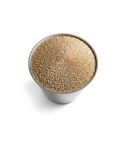 A metallic bowl filled with golden barley grains, arranged in a circular pattern