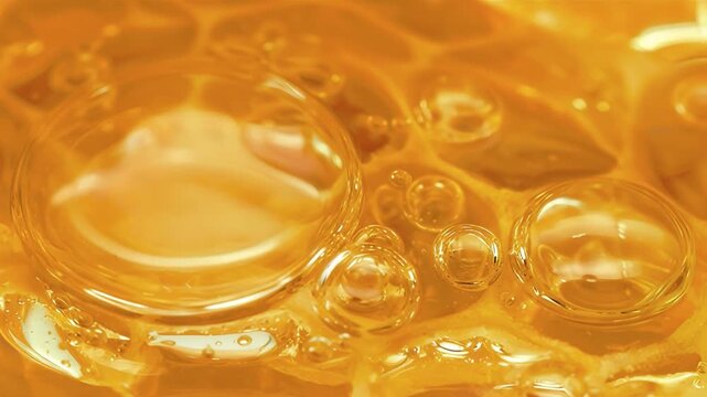 Golden glossy serum texture with translucent bubbles, conveying hydration, nourishment, and luxury premium skincare quality video, healthy food.