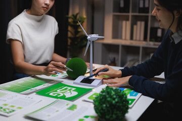 Businesswomen discussing esg strategy with renewable energy concept