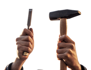 Strong male hands, one with a gold ring, holding a metal chisel and wooden hammer, raised upwards in bright light,, isolated on white background