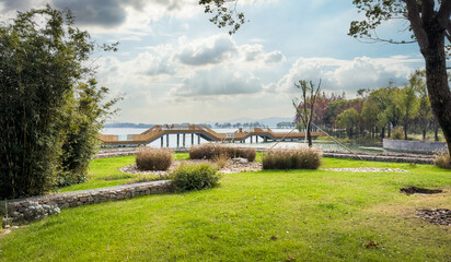 Tranquil Park Landscape with Scenic Lake and Wooden Walkway