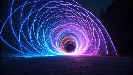Mesmerizing swirl of neon blue and purple light beams creates captivating vortex against night sky