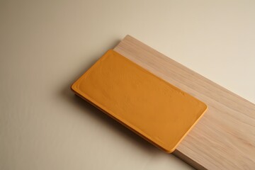 A yellow object placed on a wooden surface