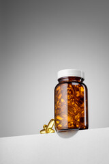 Amber pill bottle containing omega 3 dietary supplements. Hero view shot.
