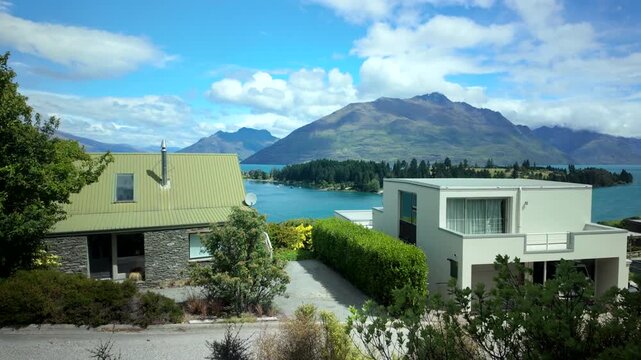 Lake and mountain view over modern houses from window