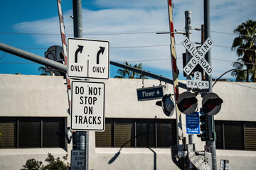 Railroad crossing signs and traffic signals with directional arrows and warnings