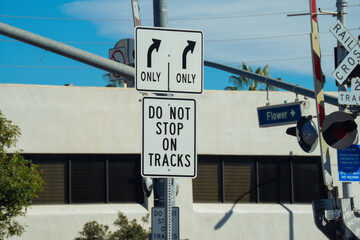 Railroad crossing signs indicate lane choices and a warning to not stop on tracks
