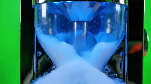 A close-up view of an ice crusher with ice cubes inside