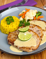Grilled Pork Tenderloin with Cream Sauce, Saffron Rice and Mixed Vegetables

