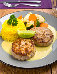 Meat Patties with White Sauce Served with Turmeric Rice and Veggies
