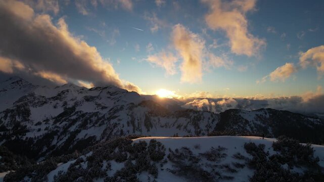 Stunning sunset drone shot in the alps during winter time.