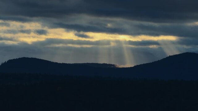 Sunlight Through Clouds Over Mountain Silhouettes In Thetis Island, British Columbia, Canada. Aerial Shot